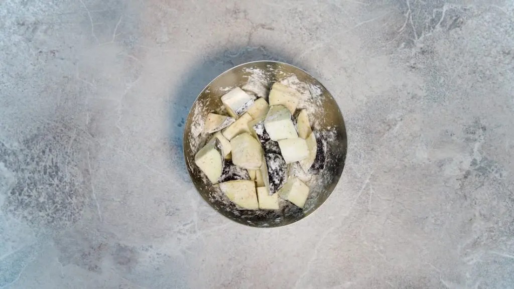 Eggplant covered in corn starch for vegan green curry