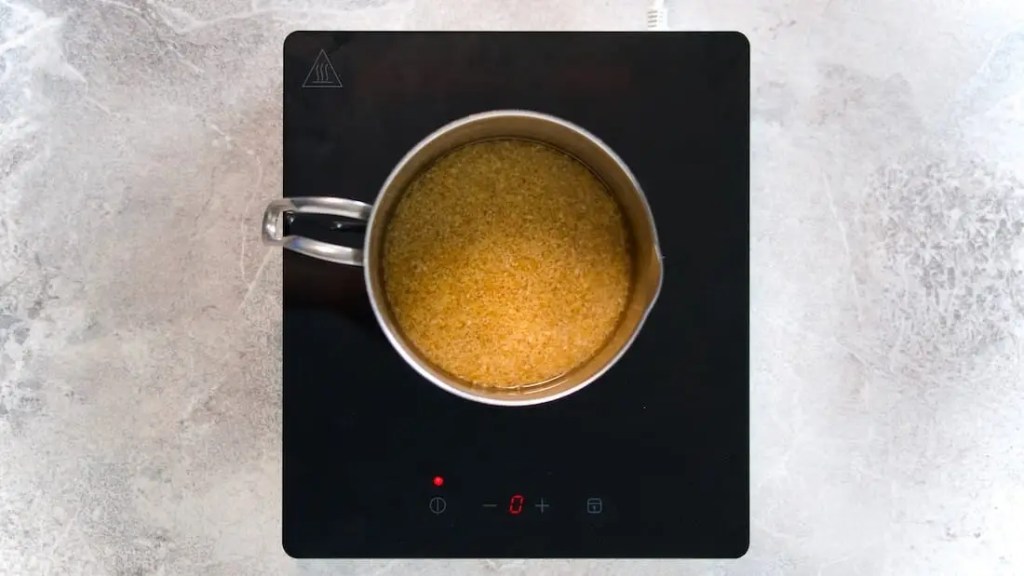 Bulgur being cooked in a pot with water for vegan bulgur salad