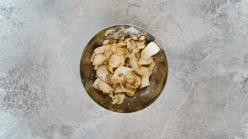 mushrooms being tossed in flour and salt