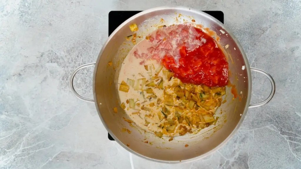 Chard curry with soy milk and tomatoes being added