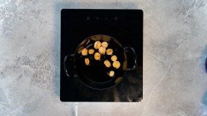 garlic being roasted in a pan