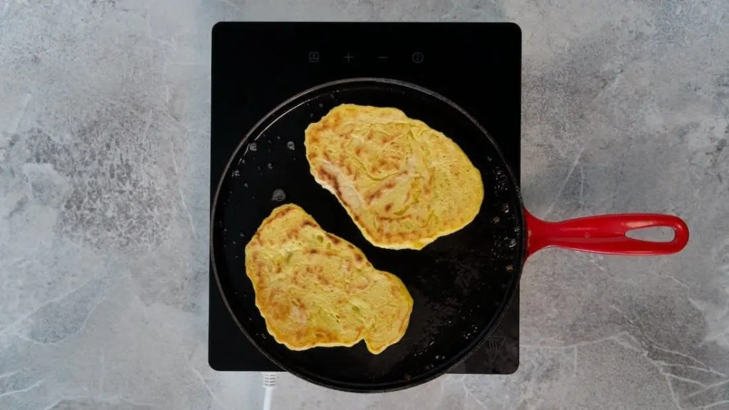 Vegan Garlic Naan bread being roasted in a pan