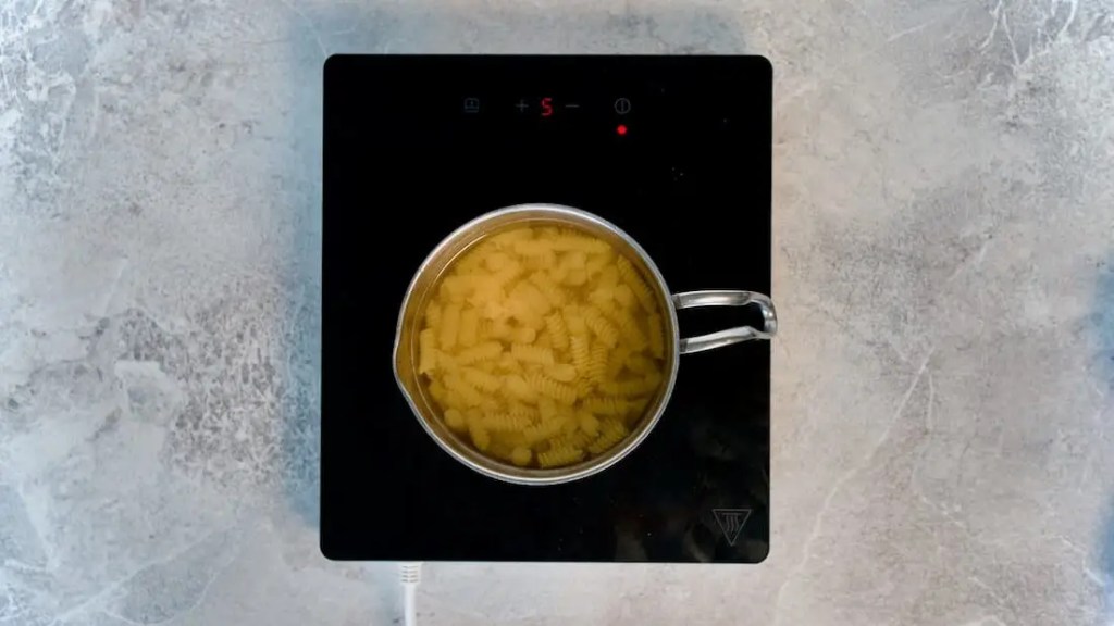Noodles cooking in a pot of water