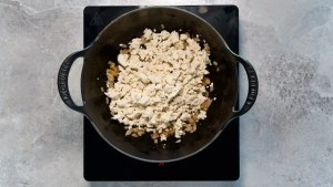 fried onions and scrambled tofu in a pot for vegan scrambled tofu