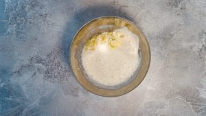 Banana mixed with soy milk and lemon in a bowl for Vegan Banana Pancakes