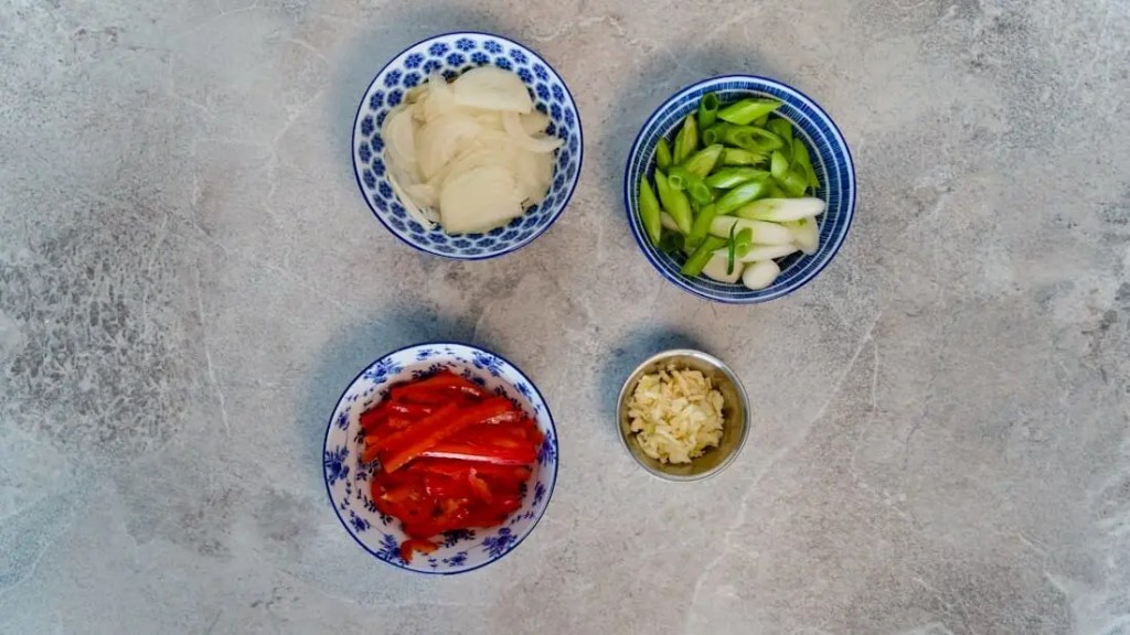 Chopped vegetables in different bowls for Vegan Pepper Tofu