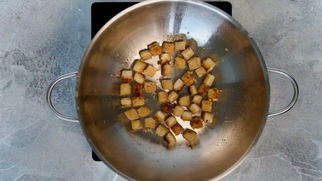 Tofu roasted crispy in a wok for Vegan Pepper Tofu