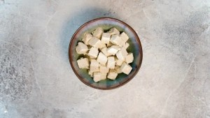 Tofu sliced into cubed and covered in cornstarch for Vegan Pepper Tofu