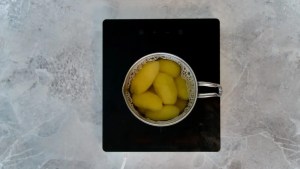 Potatoes being cooked in a pot for Vegan Potato Salad
