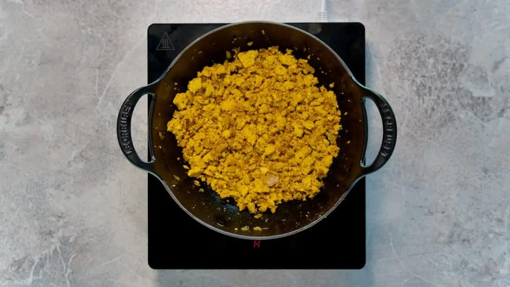 Roasted scrambled tofu with spices in a pot for vegan scrambled tofu