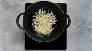 onions being fried in a pan