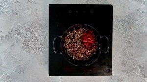 Onions and garlic with tomato paste in a pan