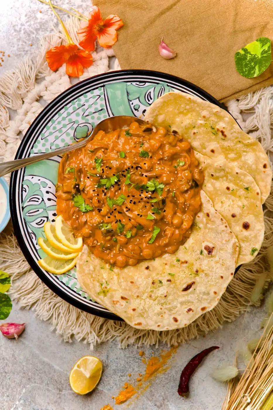 Finished chickpea curry on a plate with naan